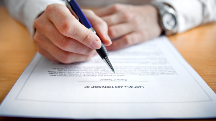 Image of a man getting ready to sign his Will